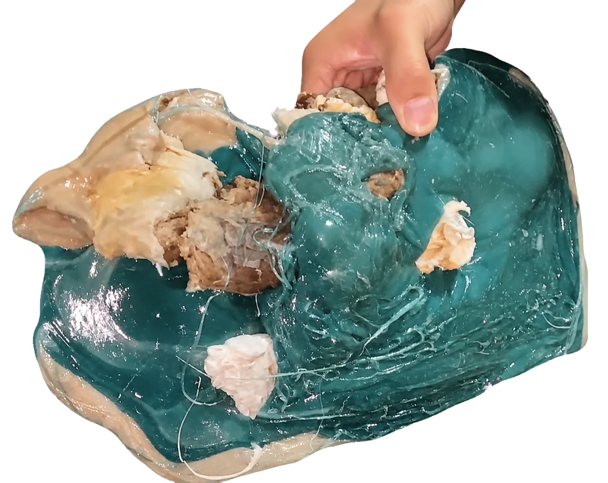 Front view of a thick, irregular plastic purge lump.