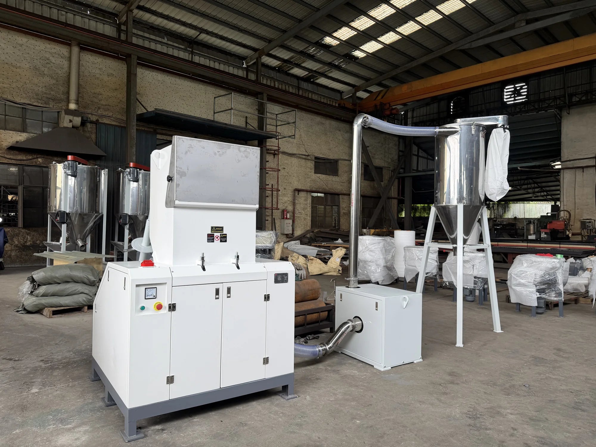 SG Silent Crusher connected to downstream material-transfer and collection equipment in the factory.