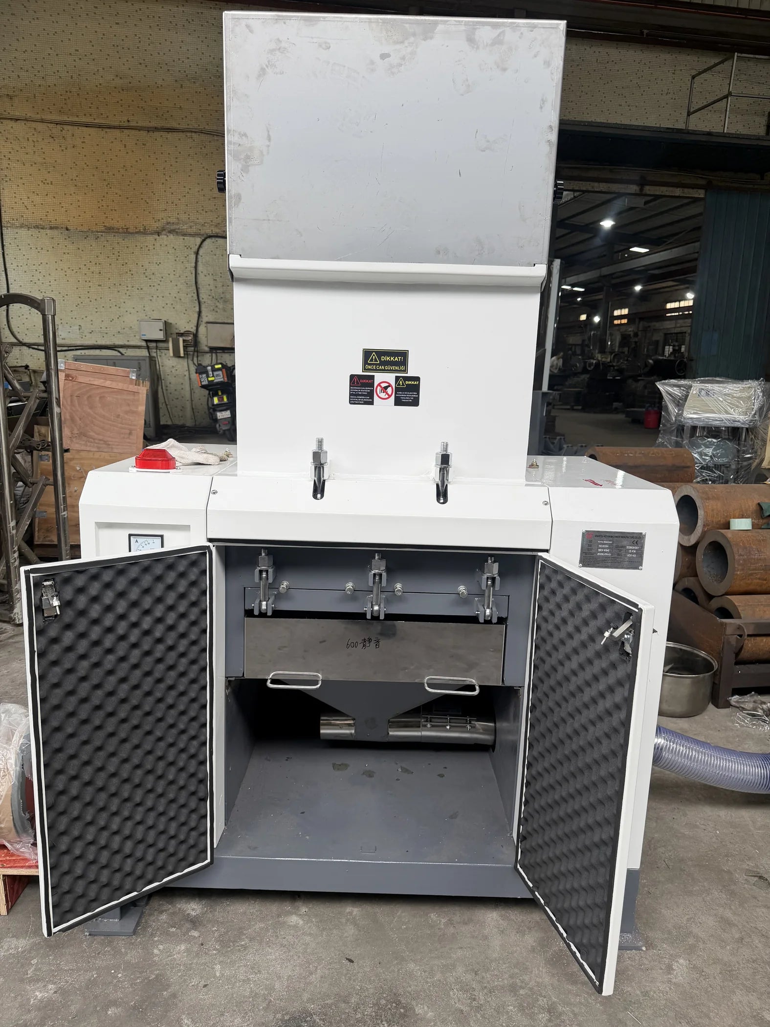 SG Silent Crusher with both lower enclosure doors open, showing the internal sound-absorbing lining and discharge area.